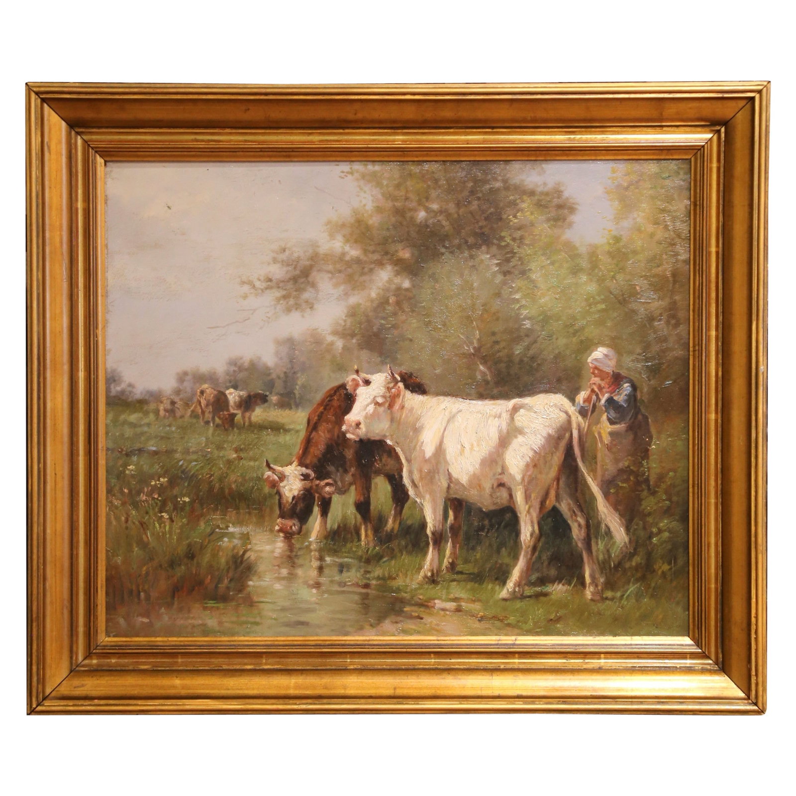Early 20th Century Oil Painting of Cattle by Stream in Giltwood Frame: Early 20th Century Oil Painting of Cattle by Stream in Giltwood Frame This exquisite early 20th-century oil painting captures a serene rural scene featuring a young farm girl tending to her cattle by