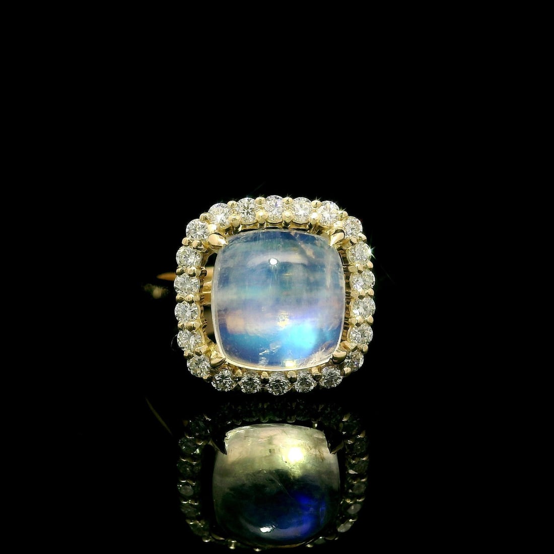 14k Yellow Gold 4.55ct Moonstone Diamond Halo Cocktail Ring: 14k Yellow Gold 4.55ct Moonstone Diamond Halo Cocktail Ring This exquisite cocktail ring features a stunning cushion-cut natural moonstone, showcased in a beautiful halo setting of sparkling diamonds.