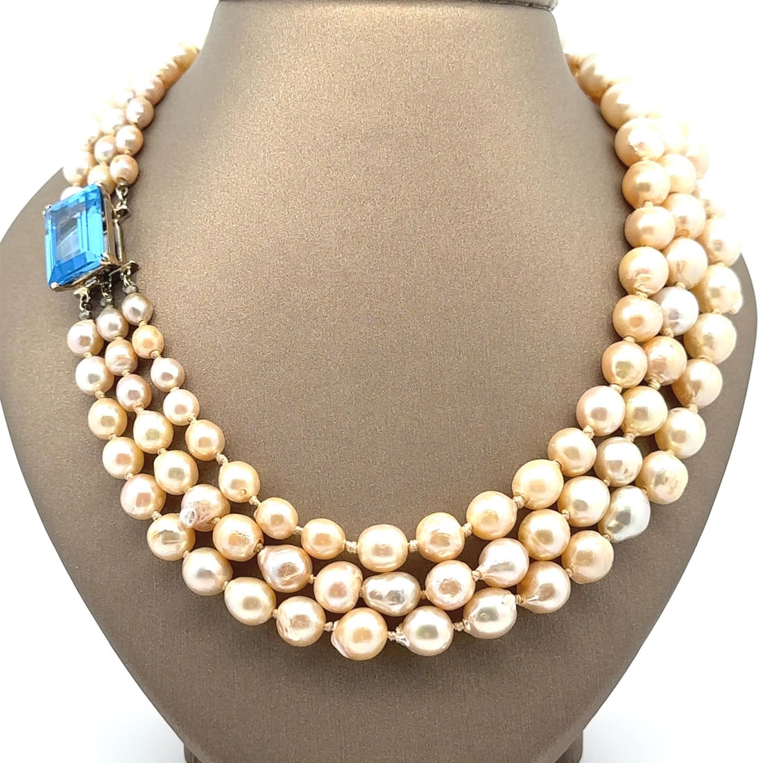 Vintage Seaman Schepps 3 Strand Pearl Necklace with Blue Spinel Clasp: Vintage Seaman Schepps 3 Strand Pearl Necklace with Blue Spinel Clasp This elegant Vintage Seaman Schepps necklace features a stunning three-strand design made from numerous genuine cultured potato pe