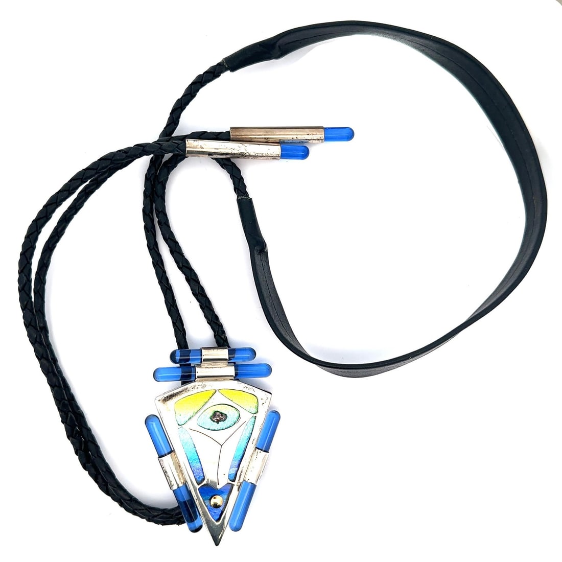 Native American Sterling Silver Bolo Tie Blue Glass Kite Pendant: Native American Sterling Silver Bolo Tie Blue Glass Kite Pendant This exquisite bolo tie features a Native American design, showcasing a stunning pendant crafted from .925 sterling silver and adorned 
