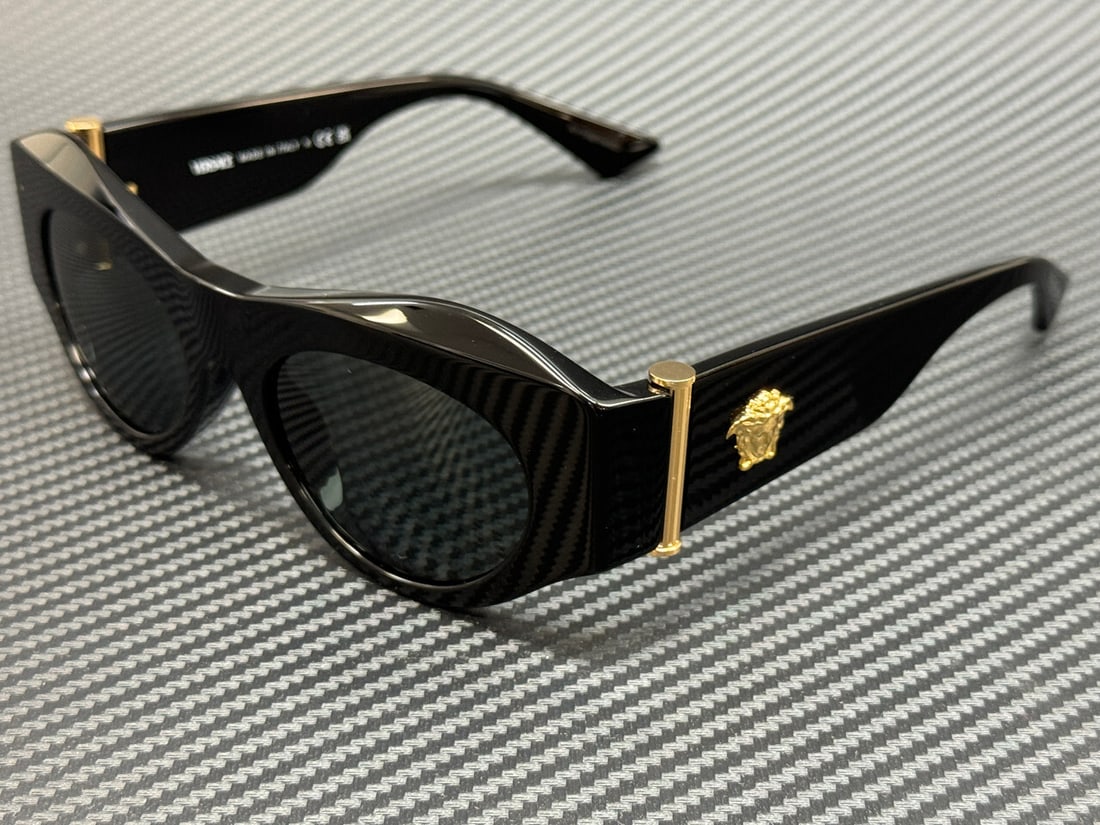 Versace VE4477U GB1 87 Black Sunglasses with Dark Grey Lenses: Versace VE4477U GB1 87 Black Sunglasses with Dark Grey Lenses Enhance your style with these elegant Versace VE4477U GB1 87 sunglasses. Featuring a sleek black frame, these 52 mm sunglasses are designe