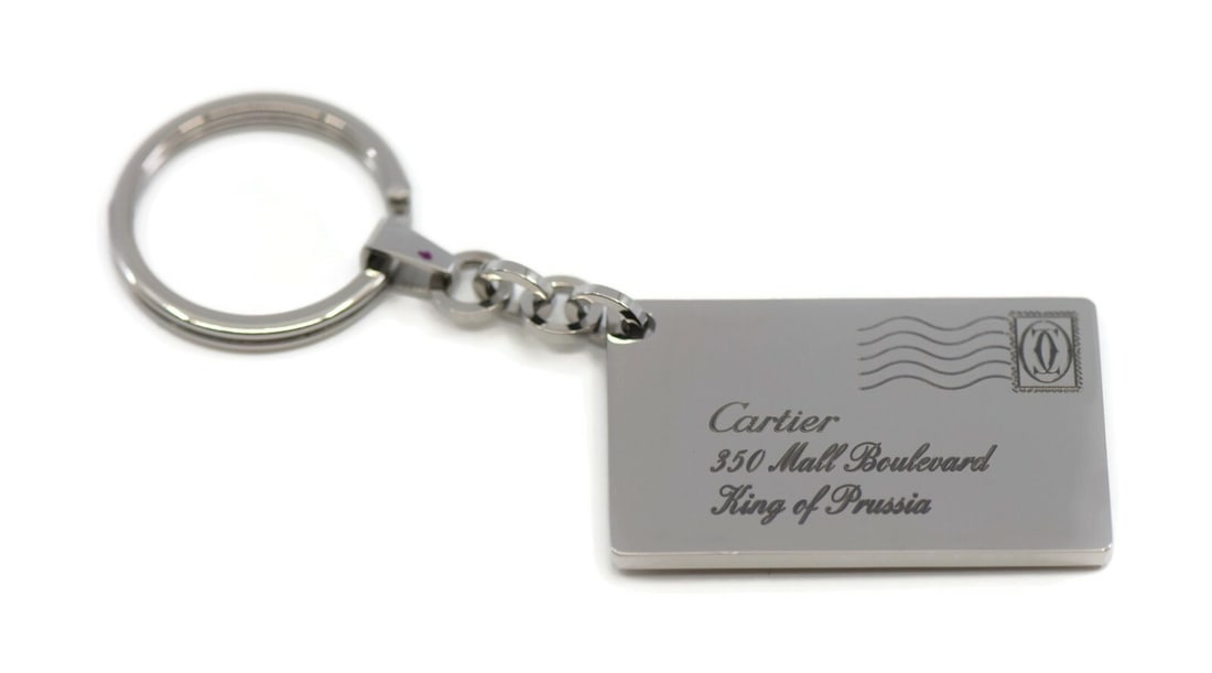 Cartier King Of Prussia Stainless Steel Key Chain Authentic with Box: Cartier King Of Prussia Stainless Steel Key Chain Authentic with Box This Cartier King Of Prussia key chain is crafted from high-quality stainless steel, exhibiting a sleek silver finish. Designed to