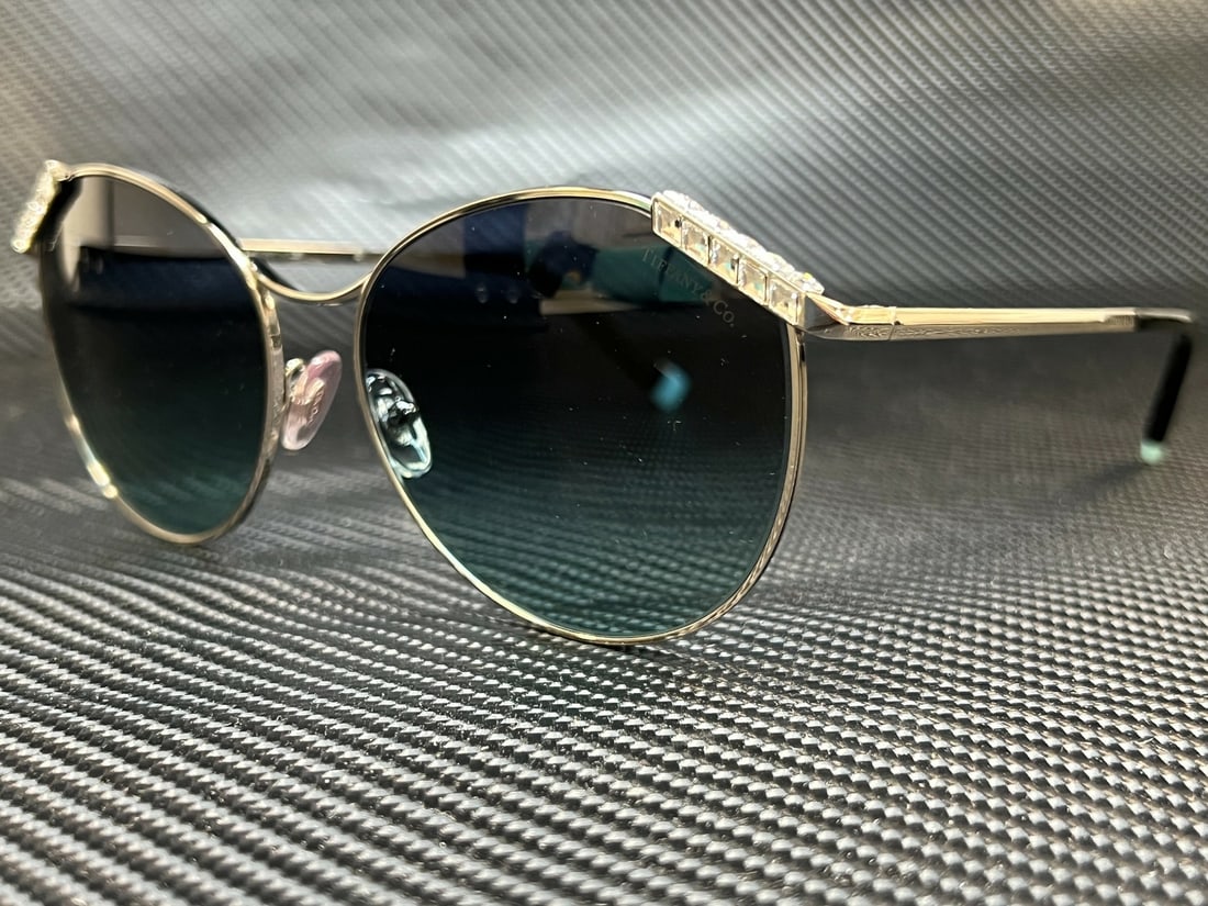 Tiffany & Co. TF3073B 60019S Silver Women's Sunglasses with Blue Gradient Lenses: Tiffany & Co. TF3073B 60019S Silver Women's Sunglasses with Blue Gradient Lenses Elevate your style with these exquisite Tiffany TF3073B 60019S women's sunglasses. Featuring a stunning silver frame, t