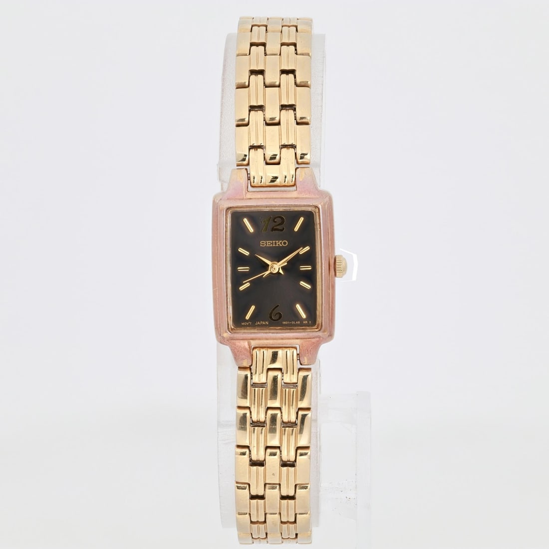 Seiko 1N01-0FH0 Gold Tone Stainless Steel Ladies Quartz Watch: Seiko 1N01-0FH0 Gold Tone Stainless Steel Ladies Quartz Watch This Seiko ladies quartz wristwatch features a striking black dial complemented by a gold tone stainless steel case and band. The watch sh