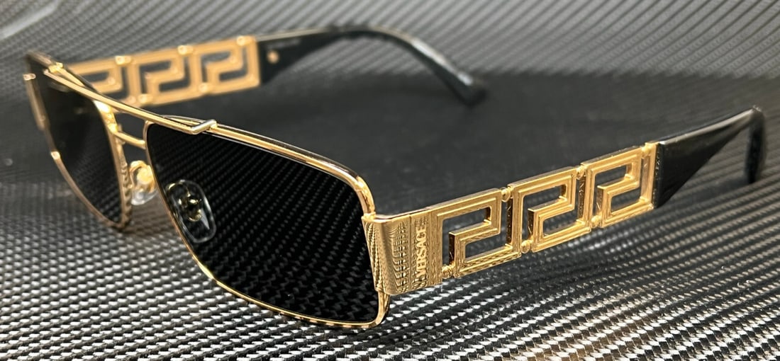 Versace VE2257 100287 Gold Geometric Sunglasses with Dark Grey Lenses: Versace VE2257 100287 Gold Geometric Sunglasses with Dark Grey Lenses Elevate your style with these Versace VE2257 sunglasses, featuring a striking geometric design. The frame is crafted from durable