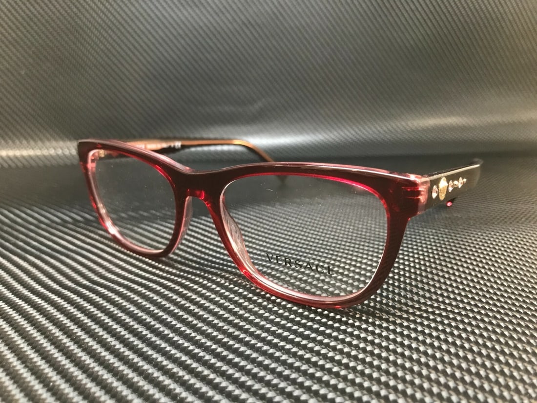 Versace VE3263B 5290 Transparent Red Square Eyeglasses for Women: Versace VE3263B 5290 Transparent Red Square Eyeglasses for Women Elevate your eyewear collection with these stylish Versace VE3263B 5290 eyeglasses. Featuring a striking square design, the frames are