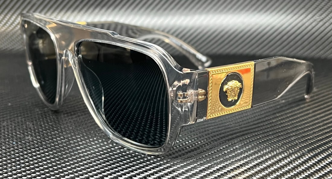 Versace VE4436U 530580 Transparent Grey Sunglasses with Box and Certificate: Versace VE4436U 530580 Transparent Grey Sunglasses with Box and Certificate Elevate your style with the Versace VE4436U 530580 sunglasses, designed for the modern man. Featuring a sophisticated transp