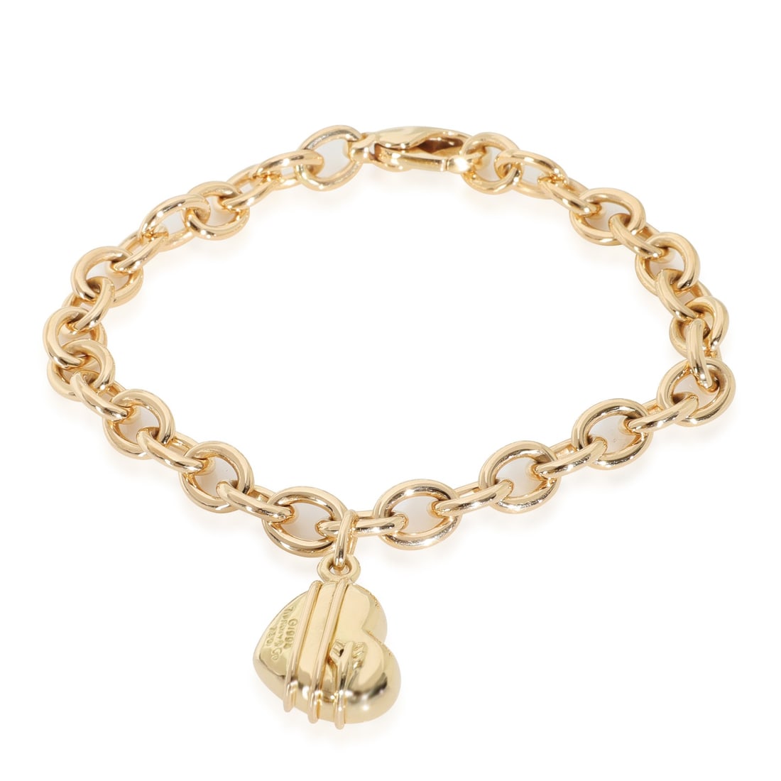 Tiffany & Co. 18k Yellow Gold Vintage Cupid's Arrow Heart Charm Bracelet: Tiffany & Co. 18k Yellow Gold Vintage Cupid's Arrow Heart Charm Bracelet This exquisite vintage bracelet from Tiffany & Co. features a charming Cupid's Arrow Heart design, elegantly crafted from high-