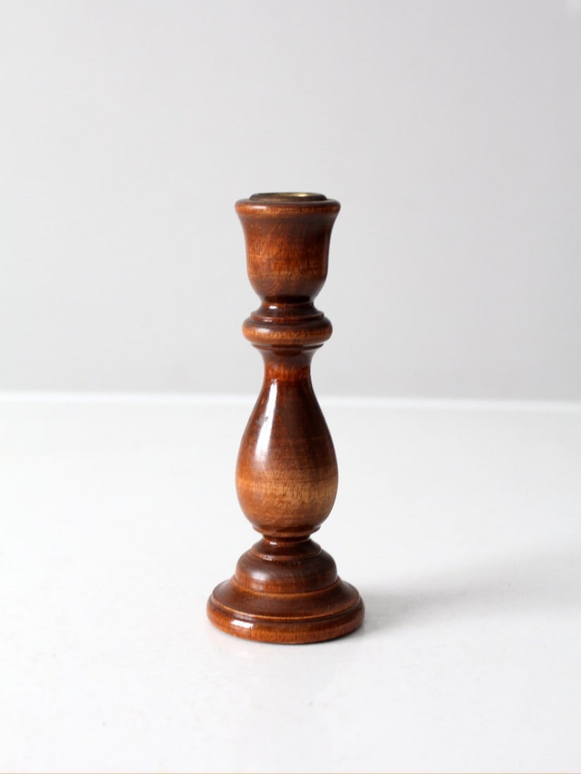 Vintage Wooden Candlestick Holder with Brass Insert and Felted Base: Vintage Wooden Candlestick Holder with Brass Insert and Felted Base This vintage wooden candlestick holder showcases a classic turned design with elegant curves and a rich brown finish. It features a