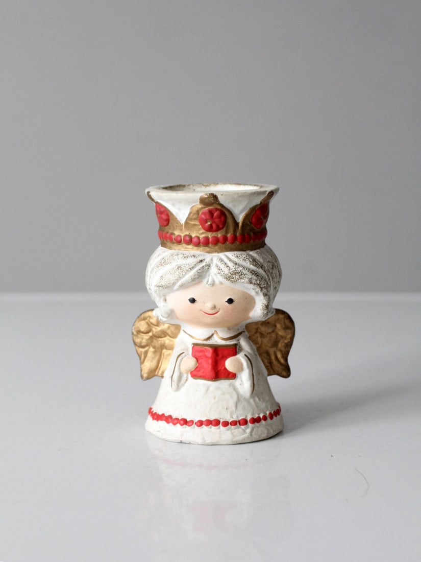 Vintage HomeCo Angel Candlestick Holder Red Gold Detailing: Vintage HomeCo Angel Candlestick Holder Red Gold Detailing Enhance your holiday decor with this vintage HomeCo angel candlestick holder. Featuring exquisite hand-painted red and gold detailing, this c