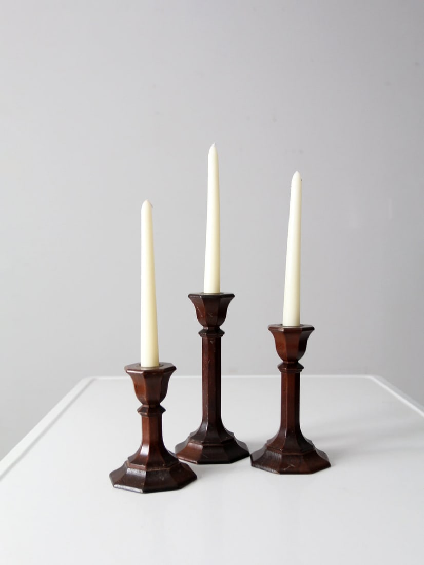 Elegant Vintage Candlestick Holders Set of 3 with Brass Sockets: Elegant Vintage Candlestick Holders Set of 3 with Brass Sockets Enhance your dining experience with this charming set of three vintage candlestick holders. Each wooden column holder is elegantly desig