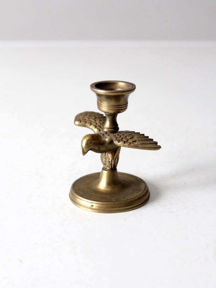 Vintage Brass Eagle Candlestick Holder with Aged Finish: Vintage Brass Eagle Candlestick Holder with Aged Finish This vintage brass candlestick holder features a beautifully detailed eagle with outstretched wings, offering a unique and striking accent for a