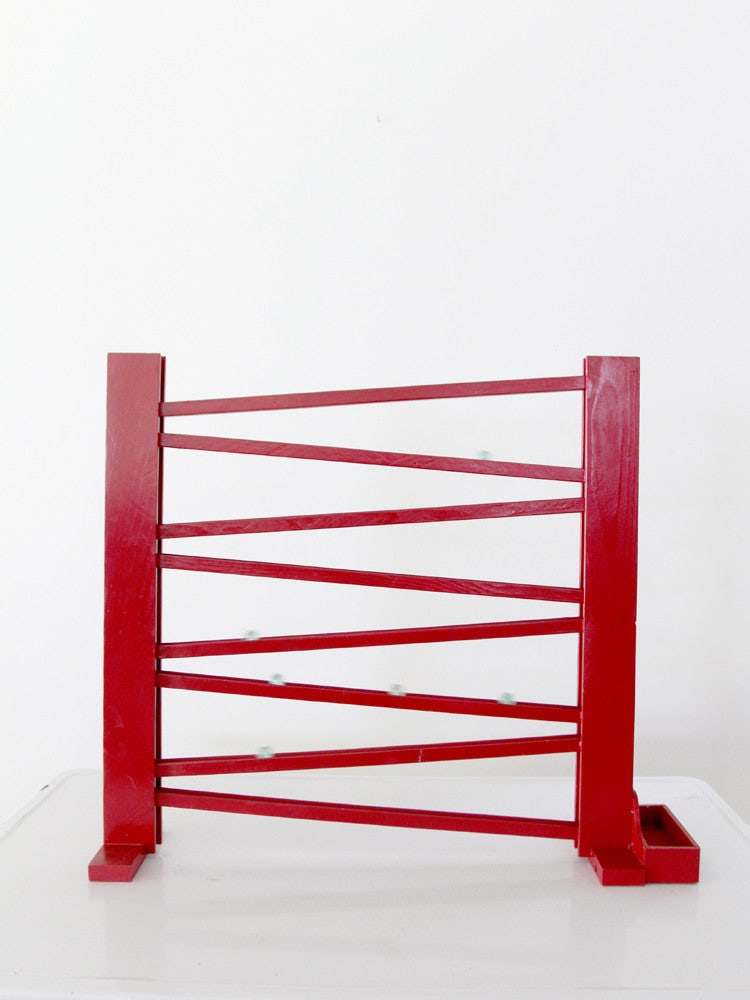 Vintage 1930s Marble Run Toy with 10 Blue Glass Marbles: Vintage 1930s Marble Run Toy with 10 Blue Glass Marbles Discover a charming vintage marble run toy from the 1930s, crafted from red wood. This delightful piece features a zigzag ramp leading to a slen