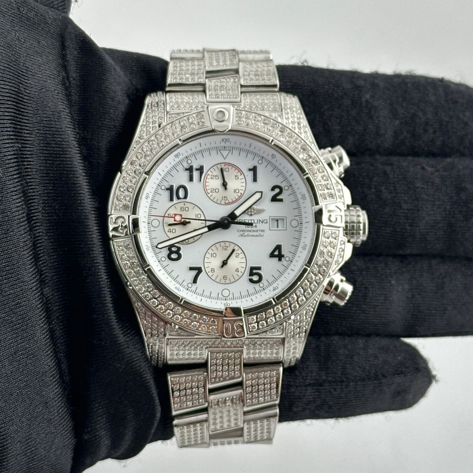 Breitling Super Avenger A13370 Diamond Bezel White Arabic Dial: Breitling Super Avenger A13370 Diamond Bezel White Arabic Dial The Breitling Super Avenger features a striking white Arabic dial complemented by a dazzling diamond bezel and bracelet, making it an eye