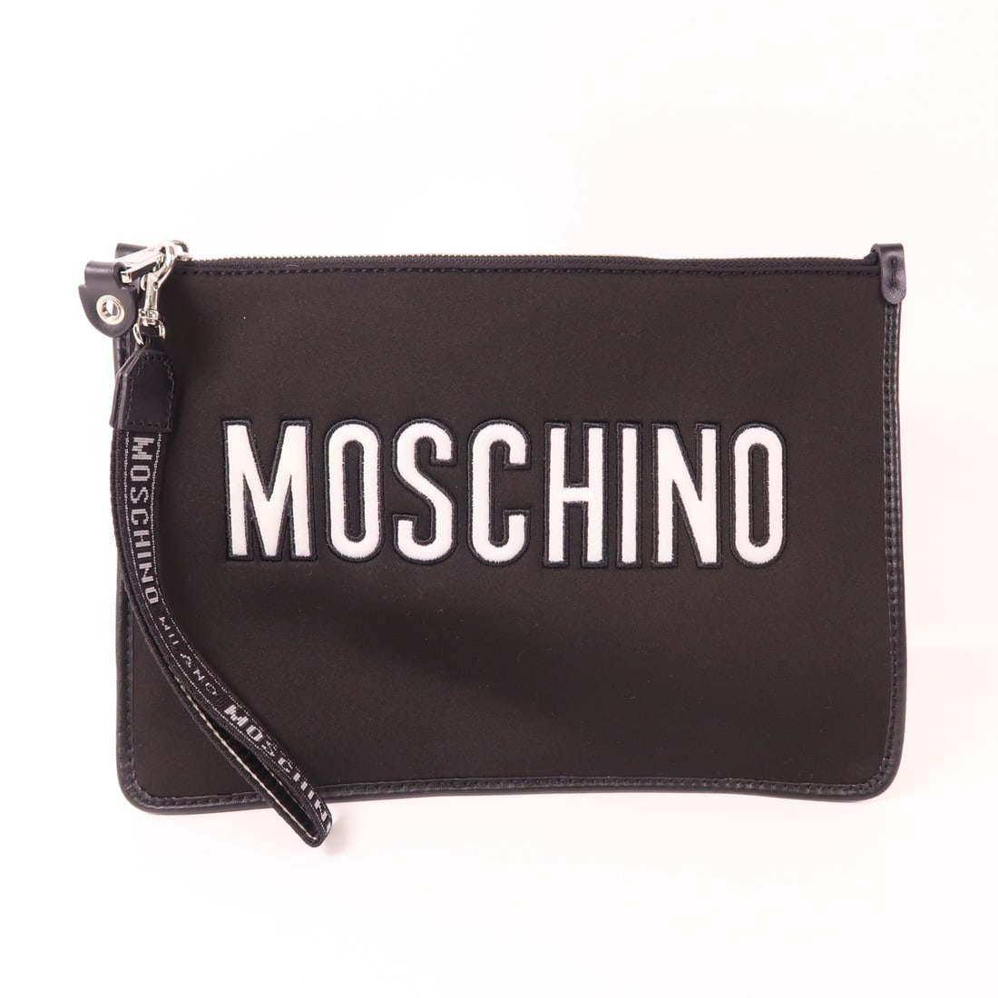 MOSCHINO Black Canvas Clutch Handbag Stylish Minimalist Design: MOSCHINO Black Canvas Clutch Handbag Stylish Minimalist Design This stylish Moschino canvas clutch is a chic accessory for any occasion. Crafted from durable black canvas, it features a sleek design w