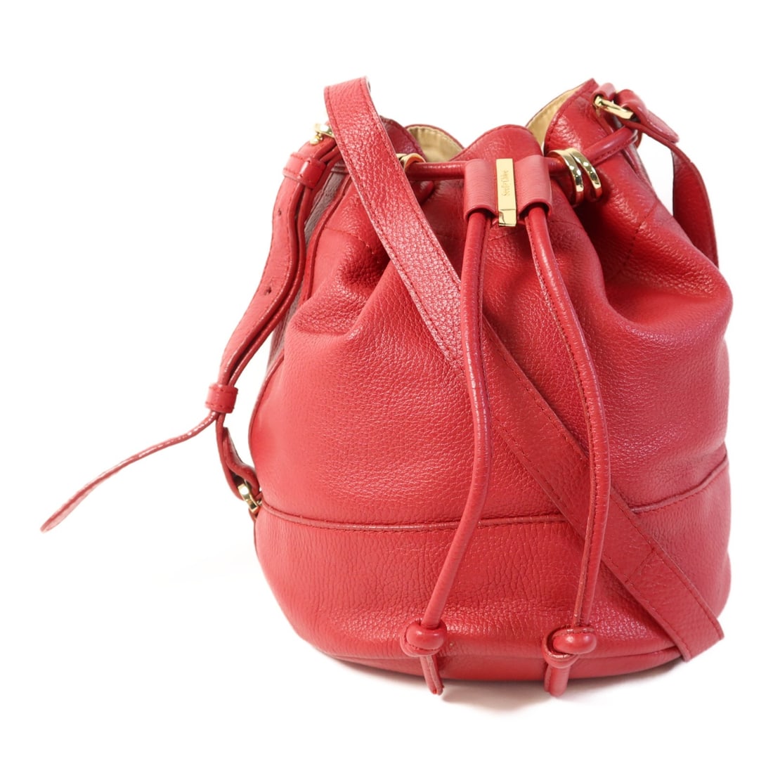 SEE BY CHLOE Red Calfskin Leather Bucket Shoulder Bag: SEE BY CHLOE Red Calfskin Leather Bucket Shoulder Bag This stylish SEE BY CHLOE bucket shoulder bag is crafted from luxurious calfskin leather in a vibrant red hue. With its compact dimensions, this b