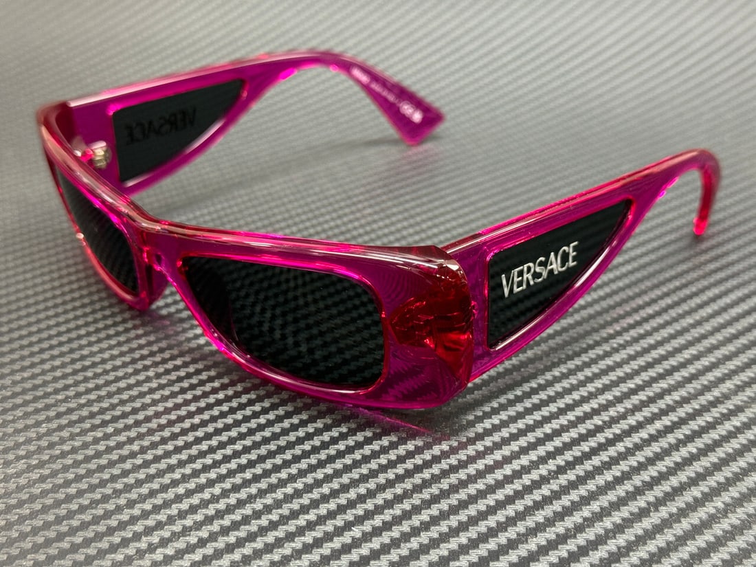 Versace VE4481 543487 Flue Transparent Pink Sunglasses with Grey Lenses: Versace VE4481 543487 Flue Transparent Pink Sunglasses with Grey Lenses Step out in style with these Versace VE4481 543487 sunglasses. The chic flue transparent pink frame beautifully complements the