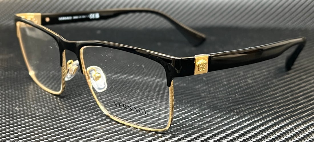 Versace VE1285 1443 Black Gold Geometric Eyeglasses with Demo Lenses: Versace VE1285 1443 Black Gold Geometric Eyeglasses with Demo Lenses Elevate your eyewear collection with these stylish Versace VE1285 eyeglasses. Featuring a striking black and gold geometric design,
