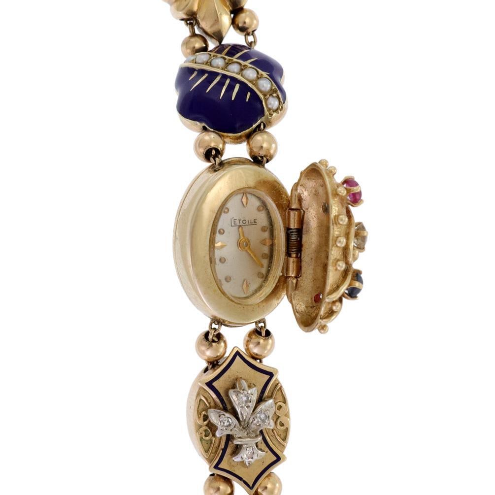 Vintage 14k Gold Hidden Watch Charm Bracelet with Diamonds and Gemstones: Vintage 14k Gold Hidden Watch Charm Bracelet with Diamonds and Gemstones This exquisite vintage charm slide bracelet features a hidden watch, beautifully crafted from 14k yellow gold. The bracelet sho