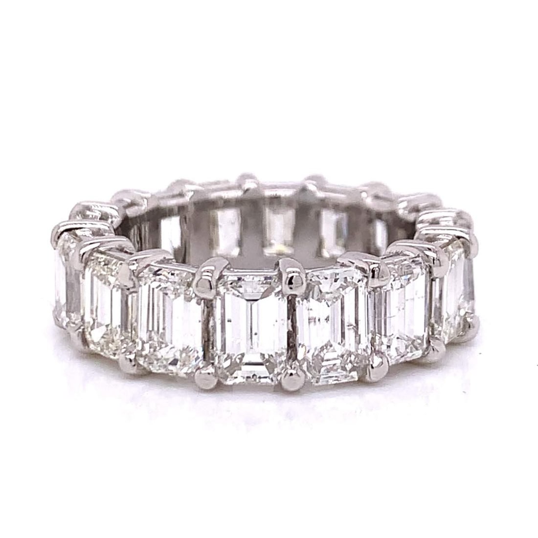 Platinum 10.75 Ct Emerald-Cut Diamond Eternity Ring: Platinum 10.75 Ct Emerald-Cut Diamond Eternity Ring Experience timeless elegance with this stunning Platinum Diamond Eternity Ring. Set with 16 exquisite Emerald-cut Diamonds, this piece boasts a tota