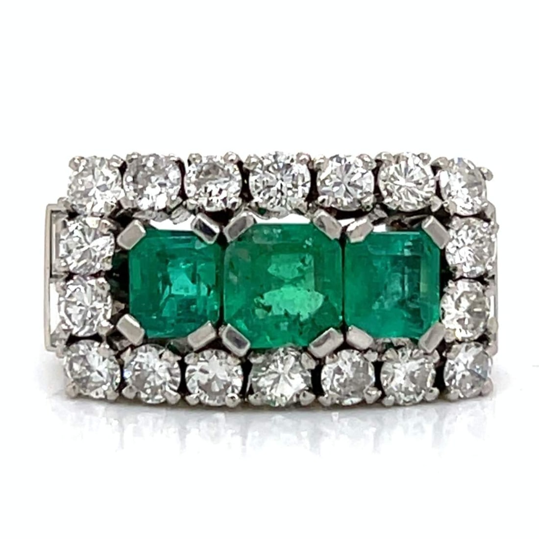 Art Deco Platinum Ring with 3 Colombian Emeralds and 22 Diamonds: Art Deco Platinum Ring with 3 Colombian Emeralds and 22 Diamonds This stunning Art Deco ring showcases a beautiful arrangement of Colombian emeralds and diamonds. Crafted from platinum, the ring featu