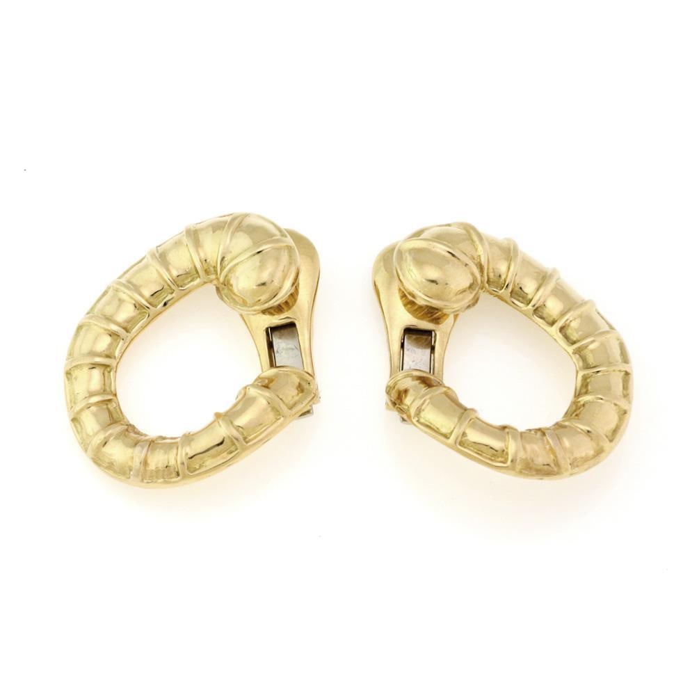 David Webb 18k Yellow Gold Shell Clip-On Earrings: David Webb 18k Yellow Gold Shell Clip-On Earrings This exquisite pair of earrings showcases the iconic craftsmanship of David Webb. Made from authentic 18k yellow gold, they feature a unique loop shel
