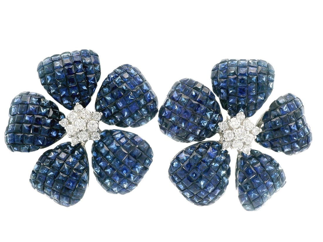 Stunning 18k White Gold Sapphire Diamond Flower Earrings: Stunning 18k White Gold Sapphire Diamond Flower Earrings Elegant and sophisticated, these stunning earrings feature a unique invisible set design adorned with an array of vibrant royal blue sapphires