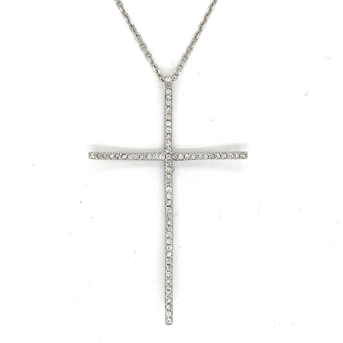 14K White Gold Diamond Cross Necklace 0.80 Ct 73 Diamonds 24 Inch Chain: 14K White Gold Diamond Cross Necklace 0.80 Ct 73 Diamonds 24 Inch Chain This exquisite necklace features a stunning curved cross pendant crafted from 14K white gold. It is adorned with 73 dazzling dia