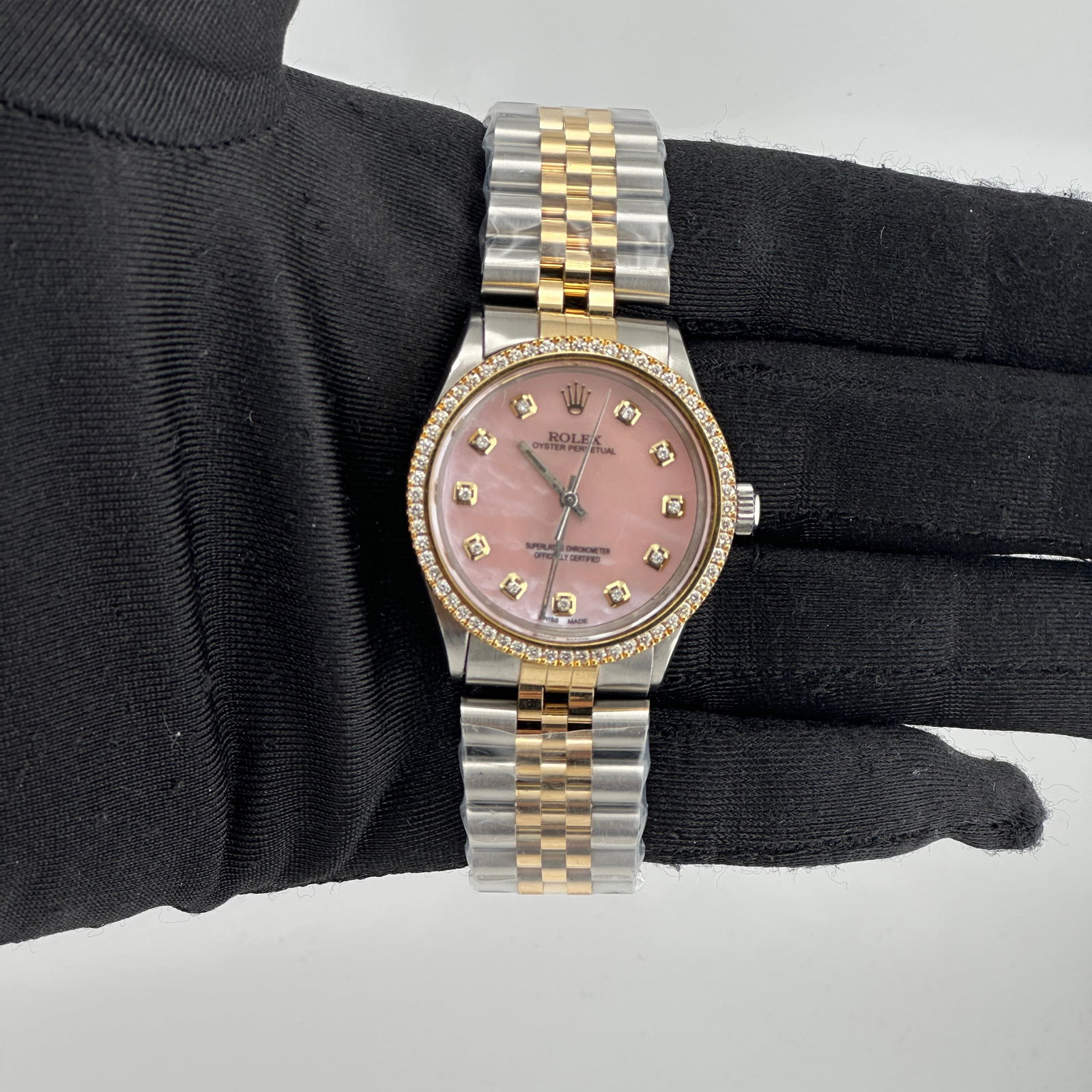 Rolex Oyster Perpetual 1002 Pink MOP Diamond Dial Jubilee Bracelet: Rolex Oyster Perpetual 1002 Pink MOP Diamond Dial Jubilee Bracelet Experience timeless elegance with the Rolex Oyster Perpetual featuring a stunning Aftermarket Pink Mother of Pearl (MOP) diamond dial