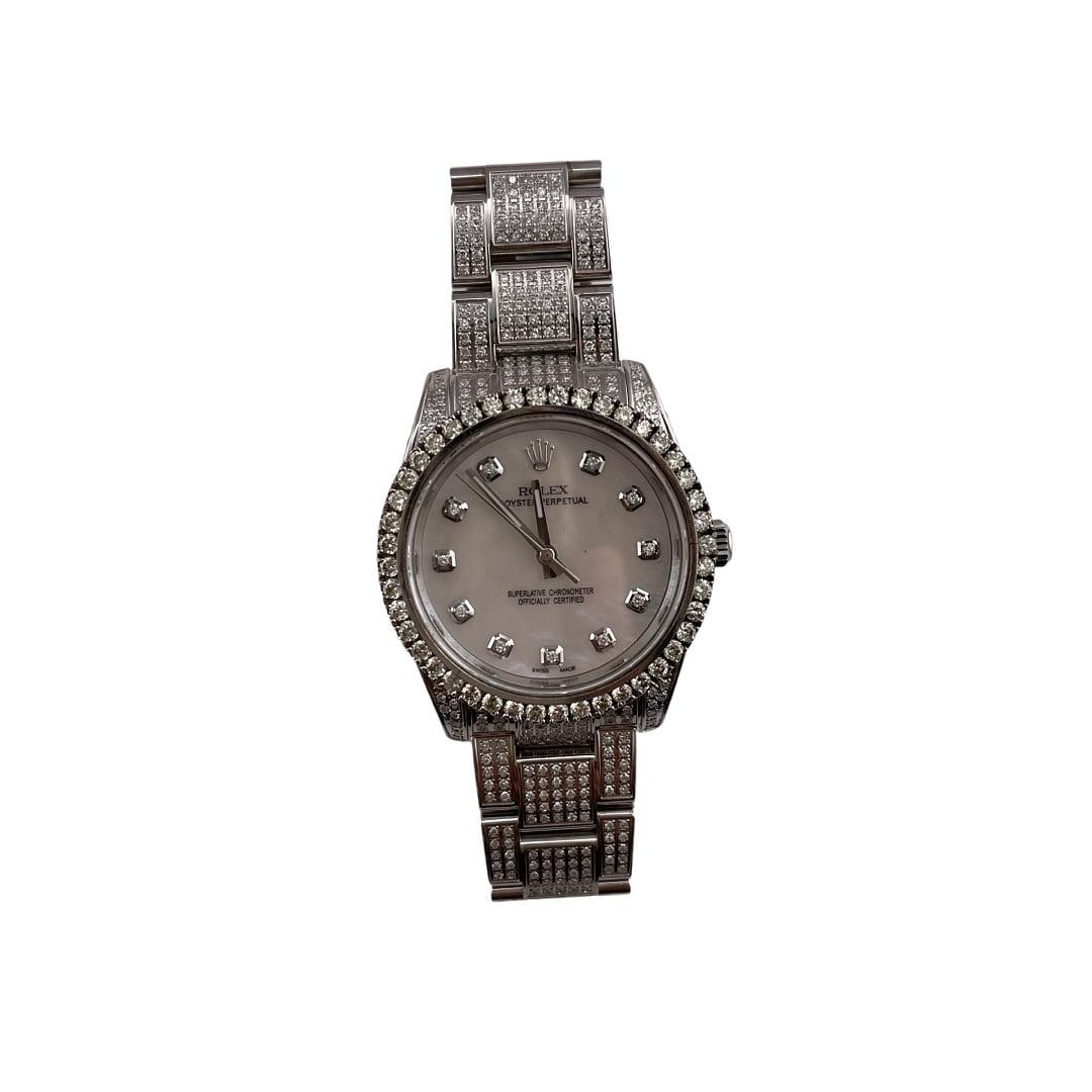 Rolex Oyster Perpetual 114200 After Market MOP Dial Diamond Bezel Unisex Watch: Rolex Oyster Perpetual 114200 After Market MOP Dial Diamond Bezel Unisex Watch This exquisite Rolex Oyster Perpetual features an alluring After Market Mother of Pearl dial enhanced with a diamond beze