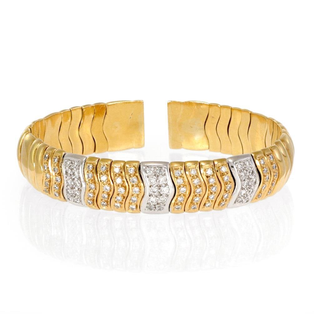 Elegant 18k Two Tone Gold Spiga Cuff Bracelet with Diamonds: Elegant 18k Two Tone Gold Spiga Cuff Bracelet with Diamonds This exquisite Estate bracelet showcases a stunning design crafted from 18k yellow and white gold. The 12mm wide cuff features a dome-shaped