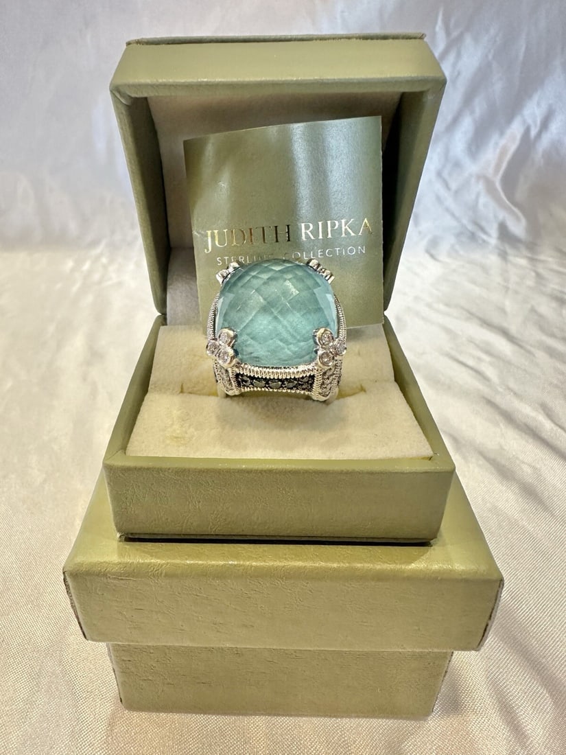 Judith Ripka 18K White Gold Topaz Diamond Ring Size 7 with Original Boxes: Judith Ripka 18K White Gold Topaz Diamond Ring Size 7 with Original Boxes Presenting a stunning Judith Ripka ring crafted in 18k white gold. This exquisite piece features a captivating topaz as the ma