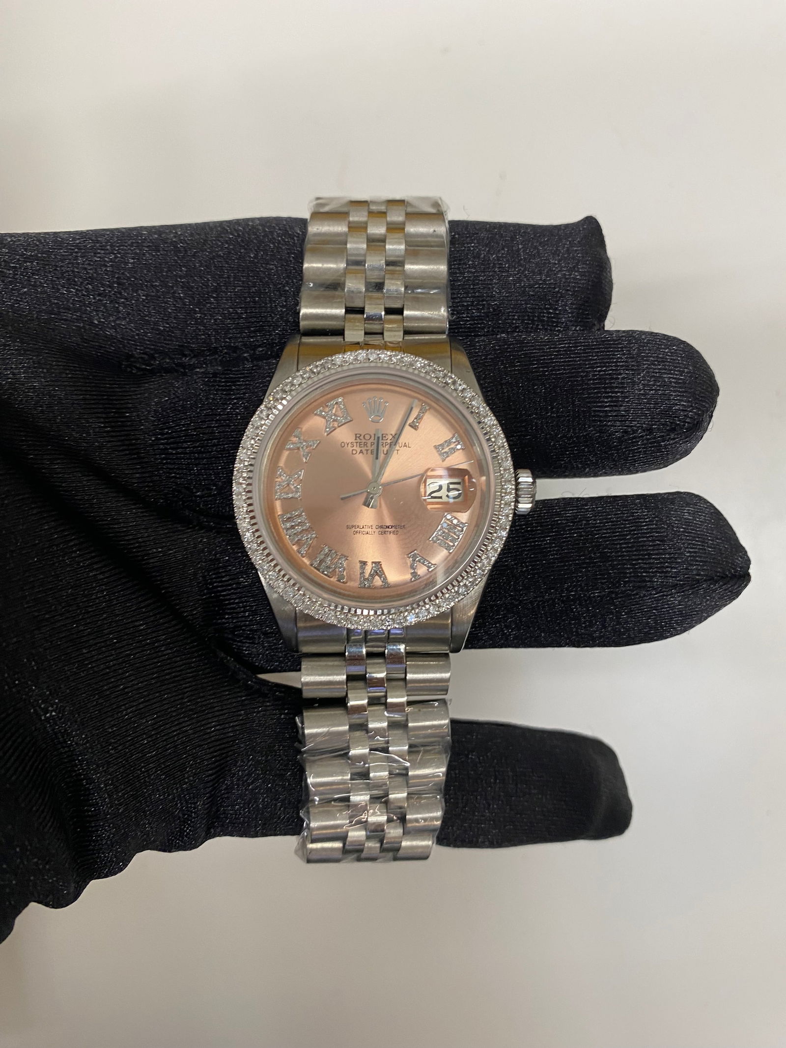 Rolex Datejust 1601 After Market Pink Roman Dial Stainless Steel Jubilee Watch: Rolex Datejust 1601 After Market Pink Roman Dial Stainless Steel Jubilee Watch This exquisite Rolex Datejust features a striking After Market Pink Roman dial, elegantly set within a prong bezel. The w