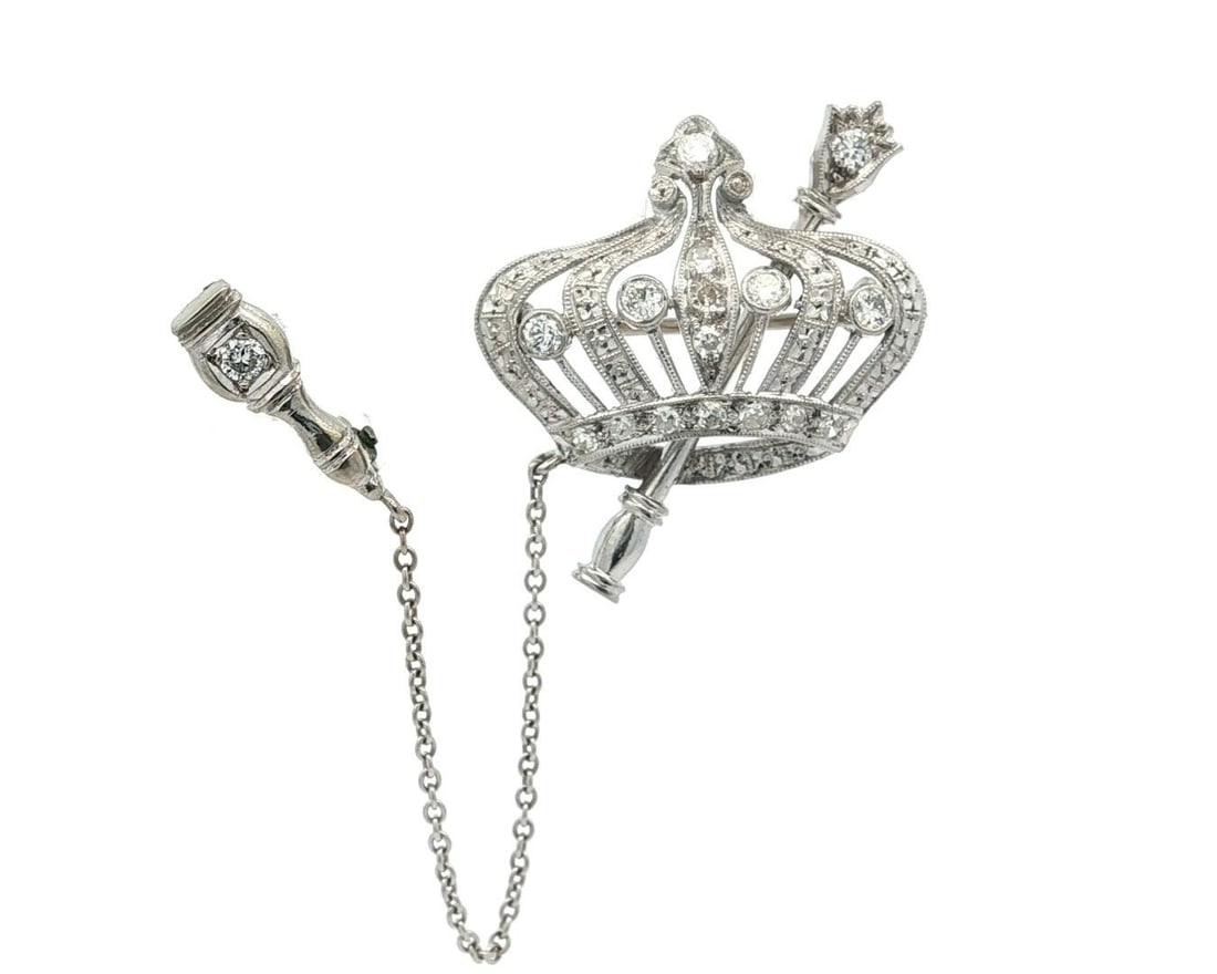 Antique Art Deco Diamond Crown & Sceptre Brooch in Platinum and Gold: Antique Art Deco Diamond Crown & Sceptre Brooch in Platinum and Gold This exquisite Antique Art Deco Brooch features a stunning royal crown design adorned with 17 natural diamonds, including round bri