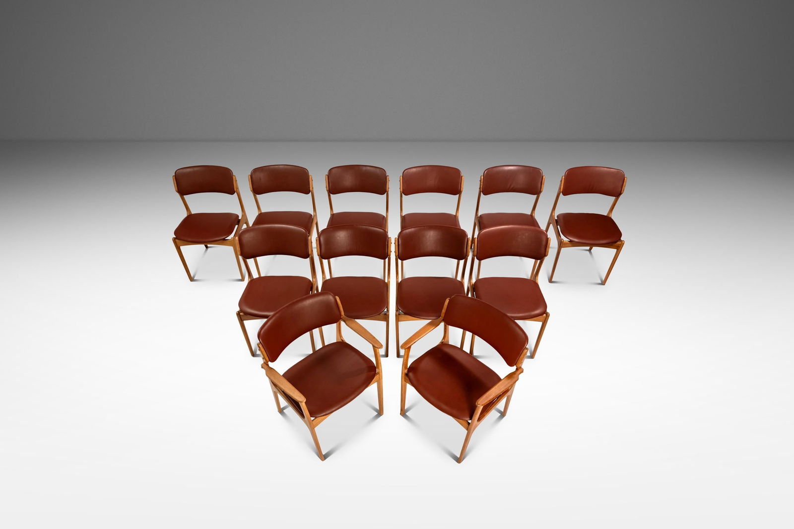 Twelve Model 49 Dining Chairs by Erik Buch in Teak & Oxblood Leather: Twelve Model 49 Dining Chairs by Erik Buch in Teak & Oxblood Leather This remarkable set includes twelve Model 49 dining chairs designed by Erik Buch for O. D. Mobler, crafted in Denmark during the 19