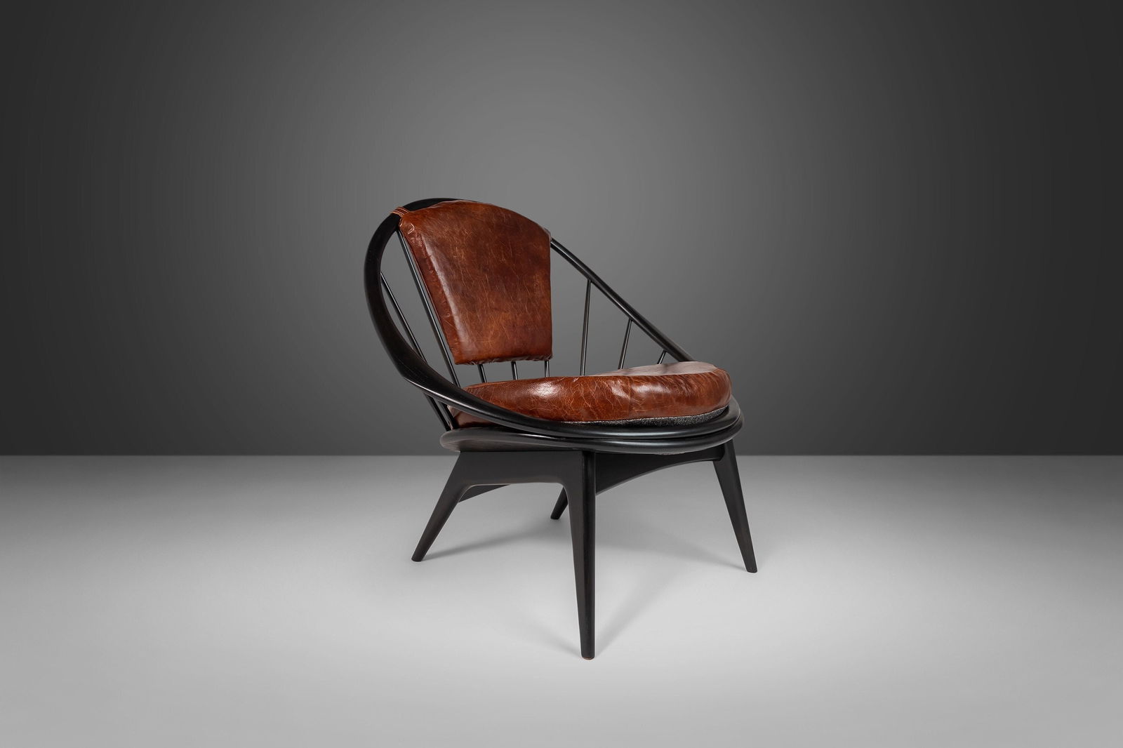Ib Kofod-Larsen Peacock Chair for Selig Ebonized Walnut with Leather: Ib Kofod-Larsen Peacock Chair for Selig Ebonized Walnut with Leather Experience the elegance of the Ib Kofod-Larsen for Selig Ebonized Hoop Chair, a stunning piece from the 1950s that showcases a scul