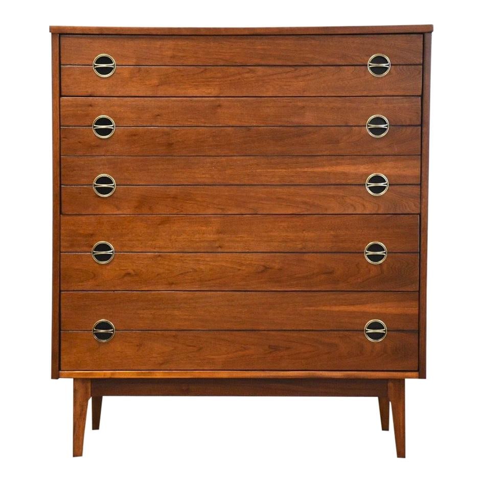 Mid Century Modern Walnut Dresser with Black Accents 43.25" Tall: Mid Century Modern Walnut Dresser with Black Accents 43.25" Tall This mid-century modern tall dresser boasts a stylish walnut construction complemented by sleek black accents and round pulls. With a w
