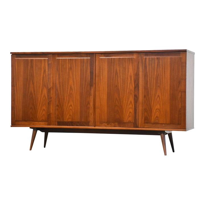 Mid-Century Modern Walnut Credenza by Founders 67" Wide: Mid-Century Modern Walnut Credenza by Founders 67" Wide This exquisite mid-century modern walnut credenza features bi-folding doors and adjustable shelves, crafted by Founders Furniture. Professionall