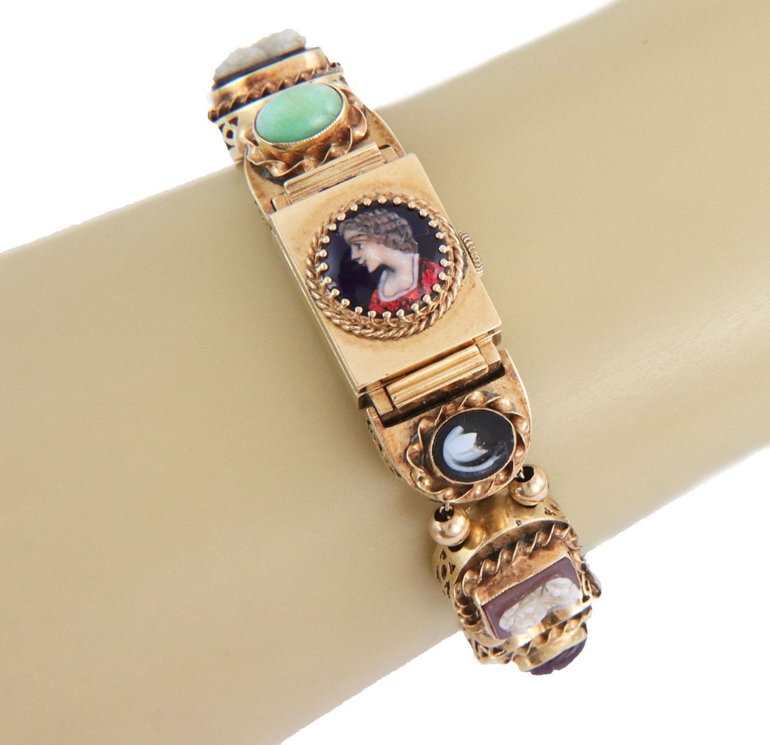 Vintage 14k Gold Slide Charms Bracelet with Hidden Watch and Gemstones: Vintage 14k Gold Slide Charms Bracelet with Hidden Watch and Gemstones Discover this exquisite vintage slide charms bracelet, expertly crafted from 14k yellow gold. This unique piece features an array