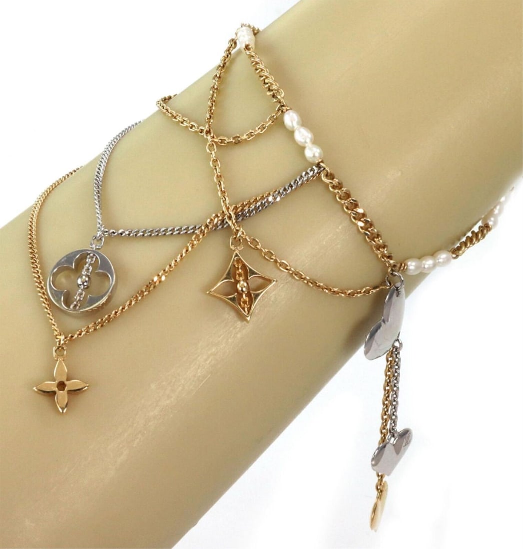 Louis Vuitton Monogram Multi-Charms 18k Gold Pearl Bracelet: Louis Vuitton Monogram Multi-Charms 18k Gold Pearl Bracelet Enhance your jewelry collection with the Louis Vuitton Monogram Pearls 18k Two Tone Gold Multi-Charms Chain Bracelet. This exquisite piece s