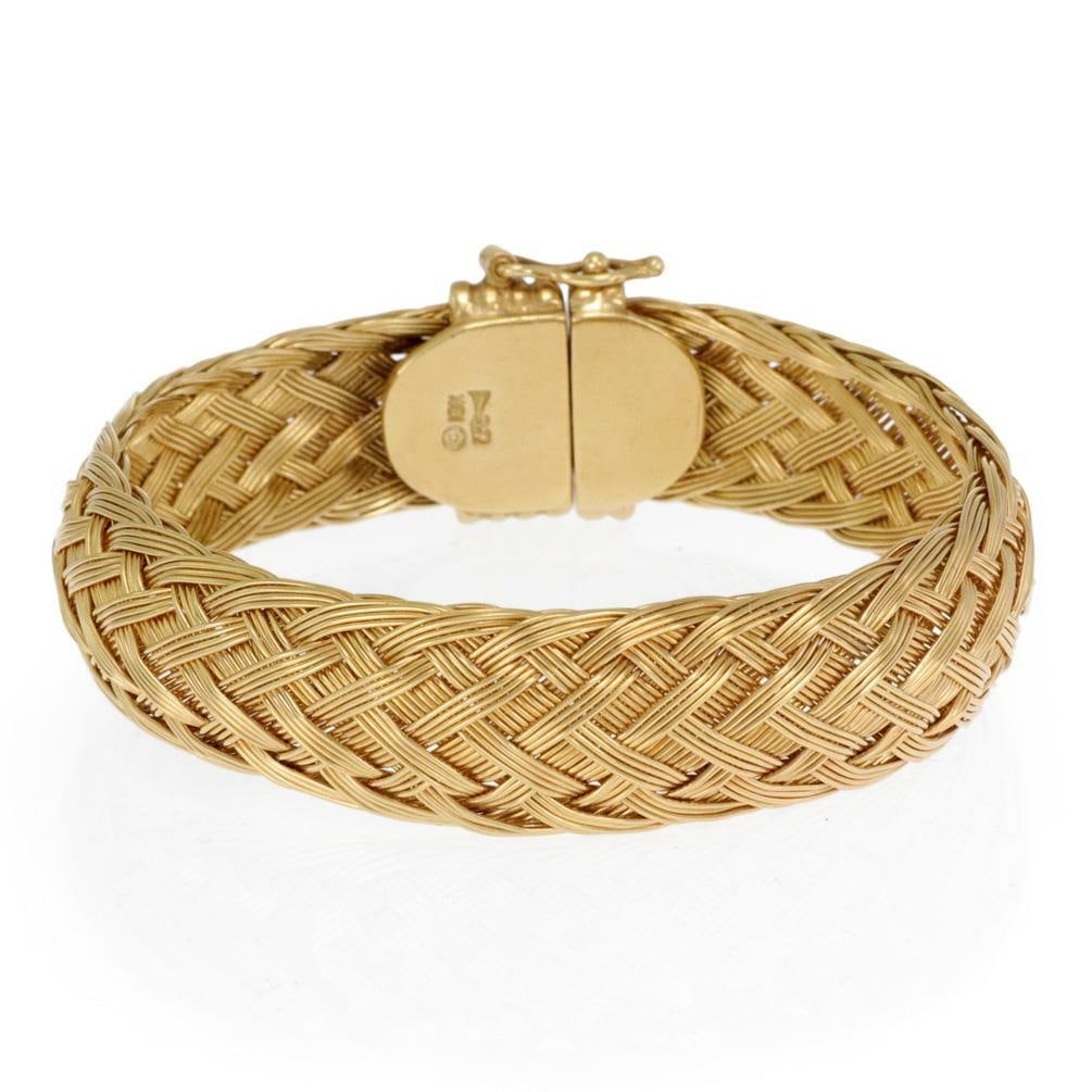 Henry Dunay 18k Yellow Gold 13mm Basket Woven Flex Bracelet: Henry Dunay 18k Yellow Gold 13mm Basket Woven Flex Bracelet This exquisite bracelet, designed by Henry Dunay, is made from luxurious 18k yellow gold. It features a stunning 13mm wide band, intricately