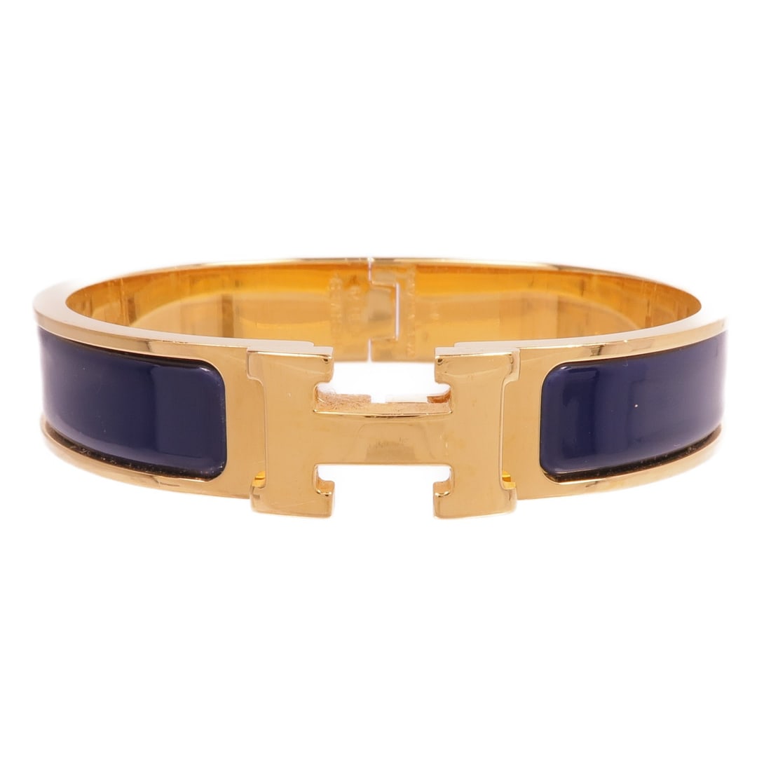 HERMES Clic H Navy Enamel Bracelet Gold Tone: HERMES Clic H Navy Enamel Bracelet Gold Tone This exquisite HERMES Clic H Bracelet features a stunning navy enamel finish that radiates elegance. Crafted in France, this bracelet combines the luxury o