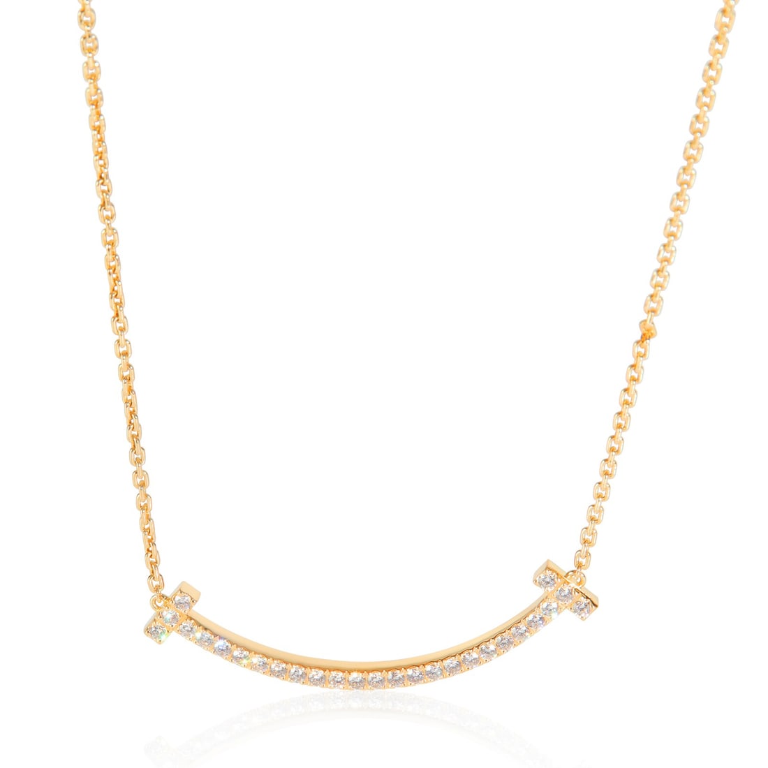 Tiffany & Co. 18k Yellow Gold Diamond Medium Tiffany T Smile Pendant: Tiffany & Co. 18k Yellow Gold Diamond Medium Tiffany T Smile Pendant This exquisite Tiffany & Co. Medium Model Tiffany T Smile Pendant is crafted from high-quality 18k yellow gold, featuring a stunnin