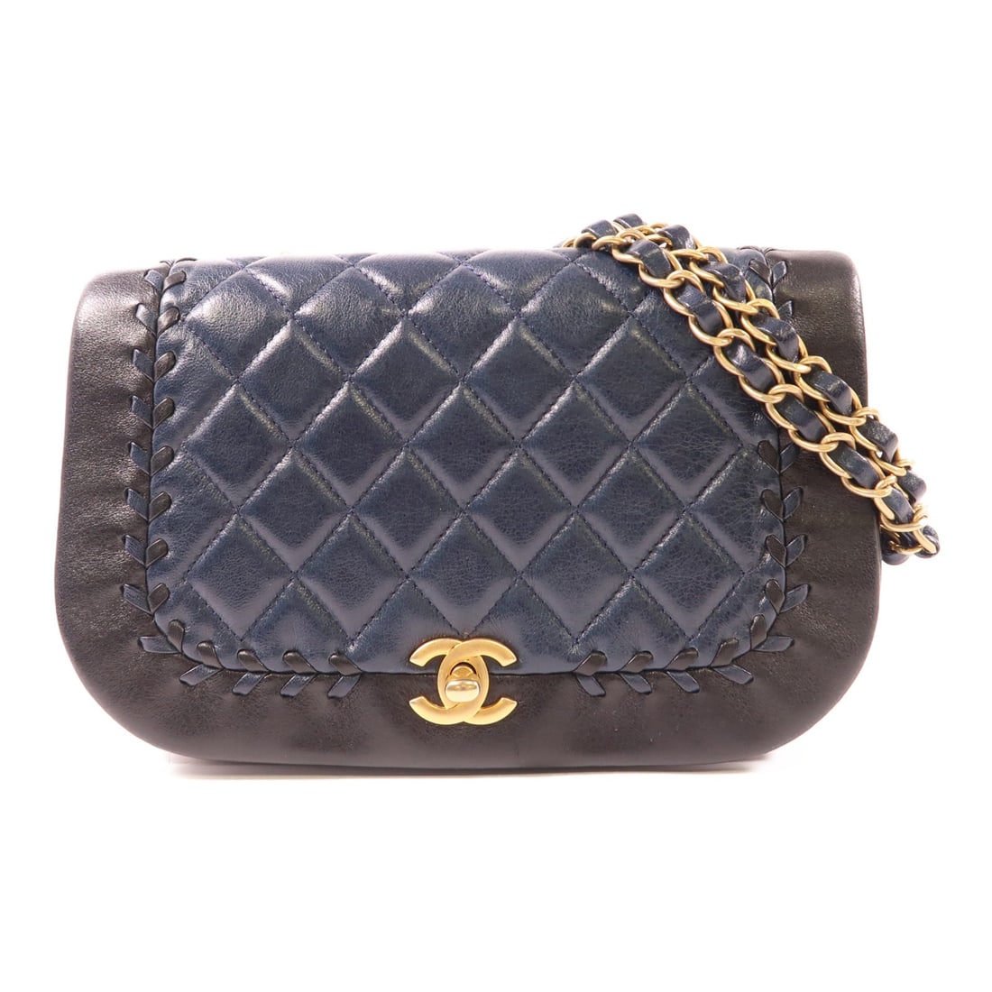 CHANEL Quilted Curve Braided Chain Shoulder Bag Navy Lambskin GHW: CHANEL Quilted Curve Braided Chain Shoulder Bag Navy Lambskin GHW This elegant CHANEL Shoulder Bag features a luxurious navy lambskin exterior, showcasing the iconic quilted design. The bag is adorned