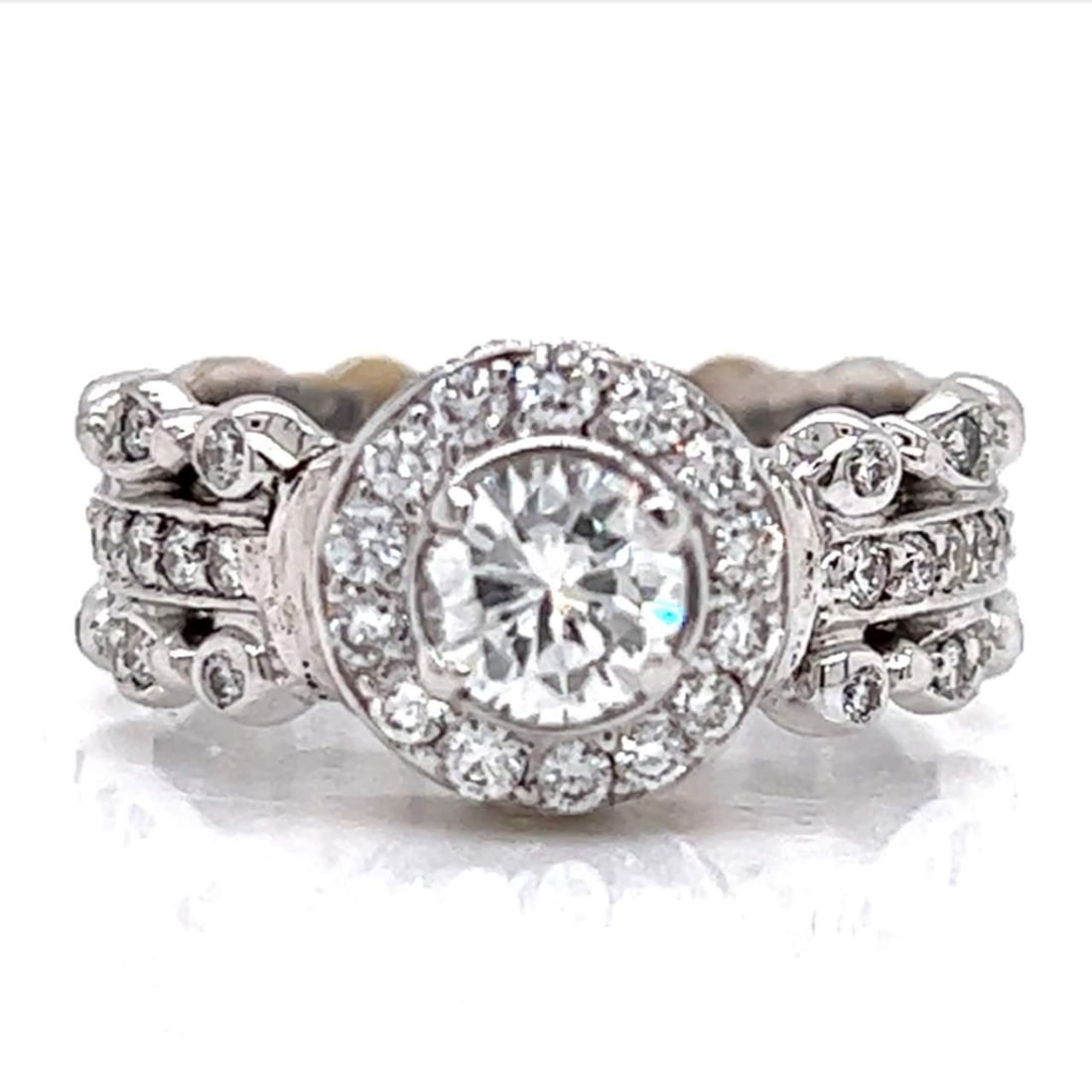 18K White Gold Diamond Ring 0.60 Ct Center 1.00 Ct Accents G-H VVS-VS: 18K White Gold Diamond Ring 0.60 Ct Center 1.00 Ct Accents G-H VVS-VS This exquisite 18K White Gold Diamond Ring showcases a stunning central diamond weighing approximately 0.60 Ct, beautifully comple