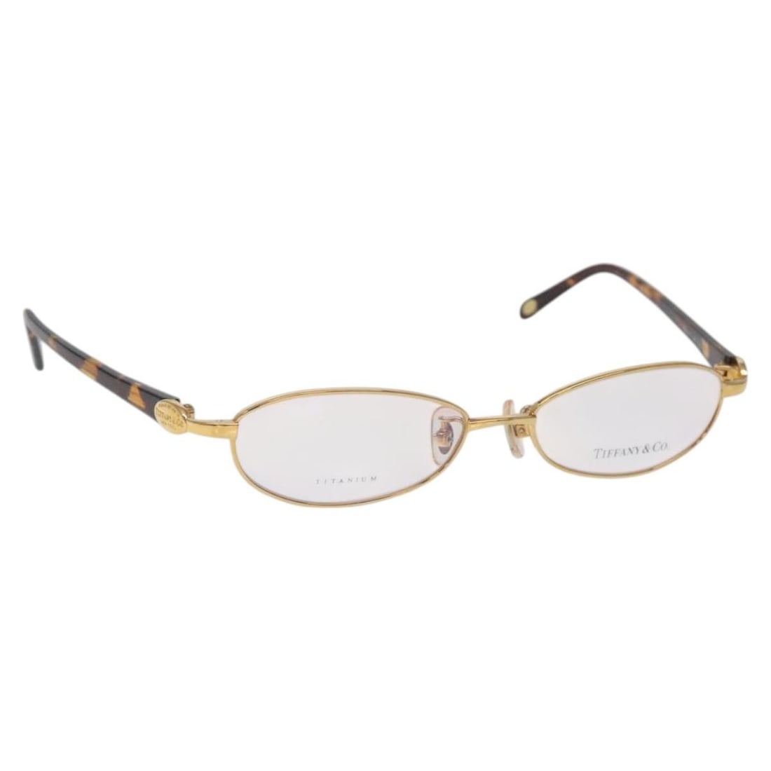 Tiffany & Co. Gold Plastic Glasses Made in Japan: Tiffany & Co. Gold Plastic Glasses Made in Japan Elevate your eyewear collection with these stylish Tiffany & Co. glasses. Crafted in Japan, these glasses feature a luxurious gold plastic finish that