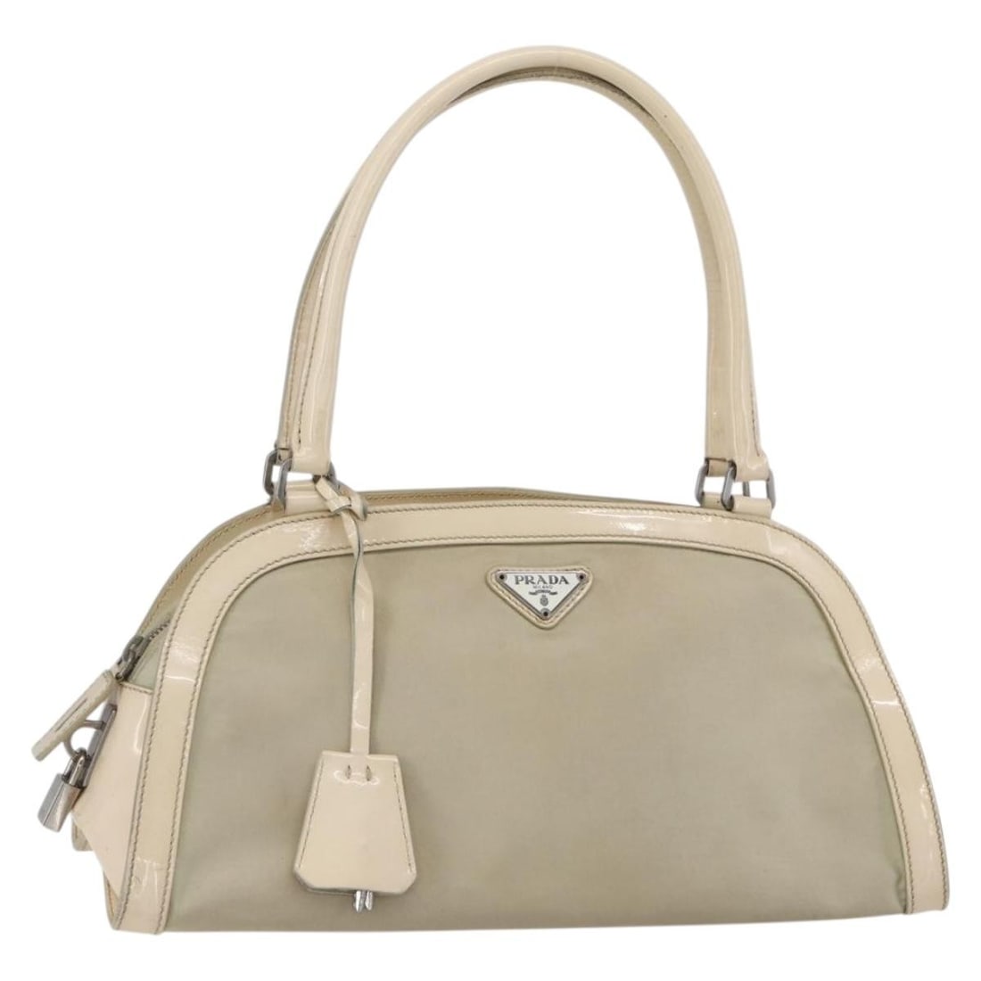 PRADA Beige Silver Nylon Shoulder Bag with Padlock Auth: PRADA Beige Silver Nylon Shoulder Bag with Padlock Auth This PRADA Shoulder Bag is crafted in Italy from durable nylon, featuring a stylish beige and silver exterior. Ideal for everyday use, it offers
