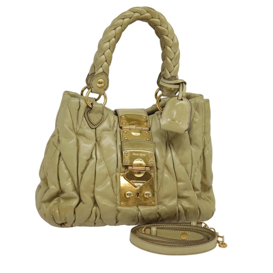Miu Miu Matelasse Leather Hand Bag Beige Gold Auth AM8291: Miu Miu Matelasse Leather Hand Bag Beige Gold Auth AM8291 This Miu Miu Matelasse Hand Bag is a stylish accessory crafted from high-quality leather in a chic beige and gold color combination. It featur