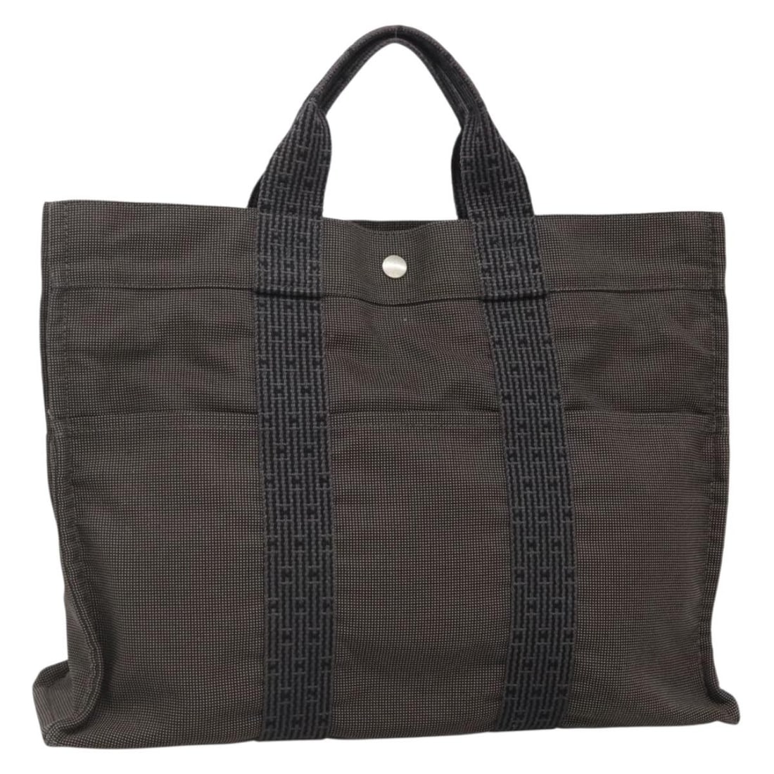 HERMES Her Line MM Gray Silver Canvas Hand Bag Made in France: HERMES Her Line MM Gray Silver Canvas Hand Bag Made in France Introducing the HERMES Her Line MM Hand Bag, an exquisite combination of style and functionality. Crafted from high-quality canvas, this e