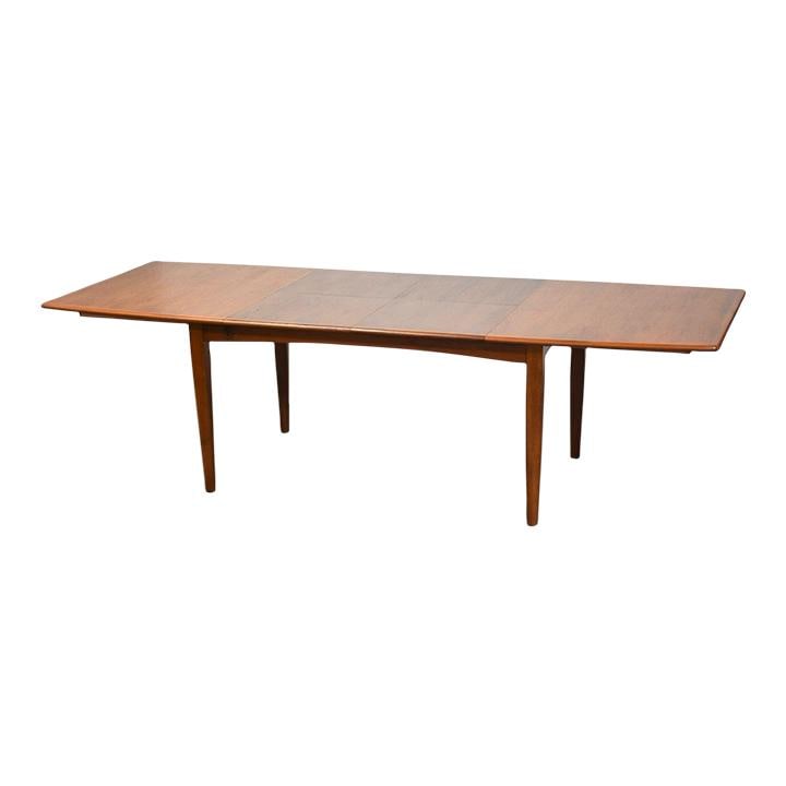 1960s Danish Modern Teak Butterfly Leaf Dining Table 101.125": 1960s Danish Modern Teak Butterfly Leaf Dining Table 101.125" This elegant mid-century modern dining table features a stunning Danish design made from high-quality teak. The table showcases a self-sto